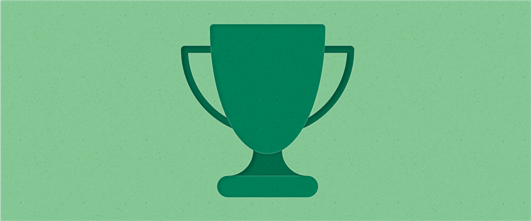A dark green hued award in the shape of a cup with handles appears on a light green background