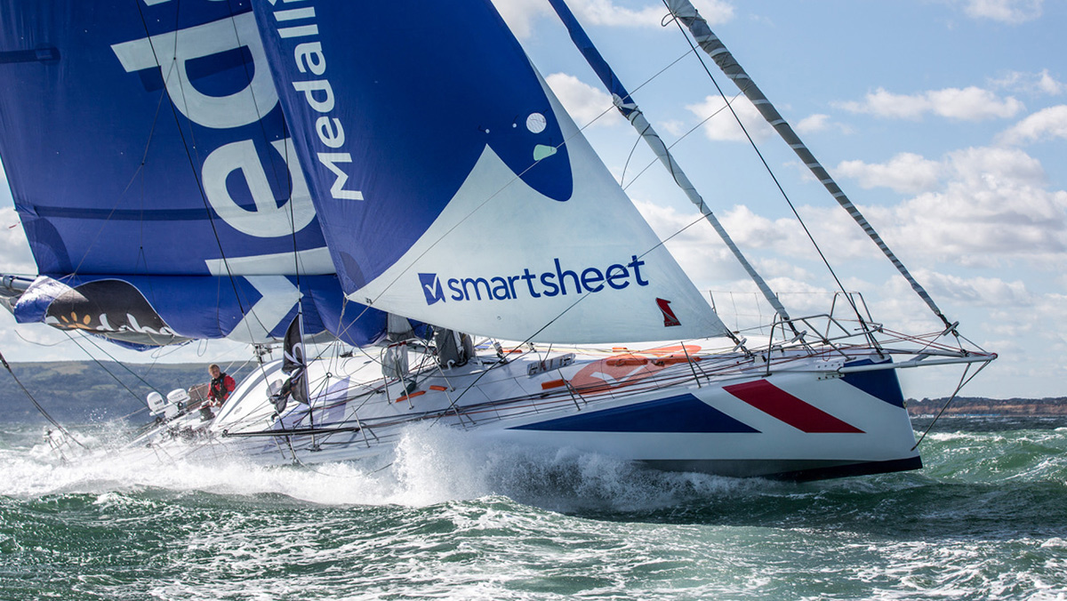 The Smartsheet logo appears on the sail of the Medallia, Pip Hare's competitive sail boat