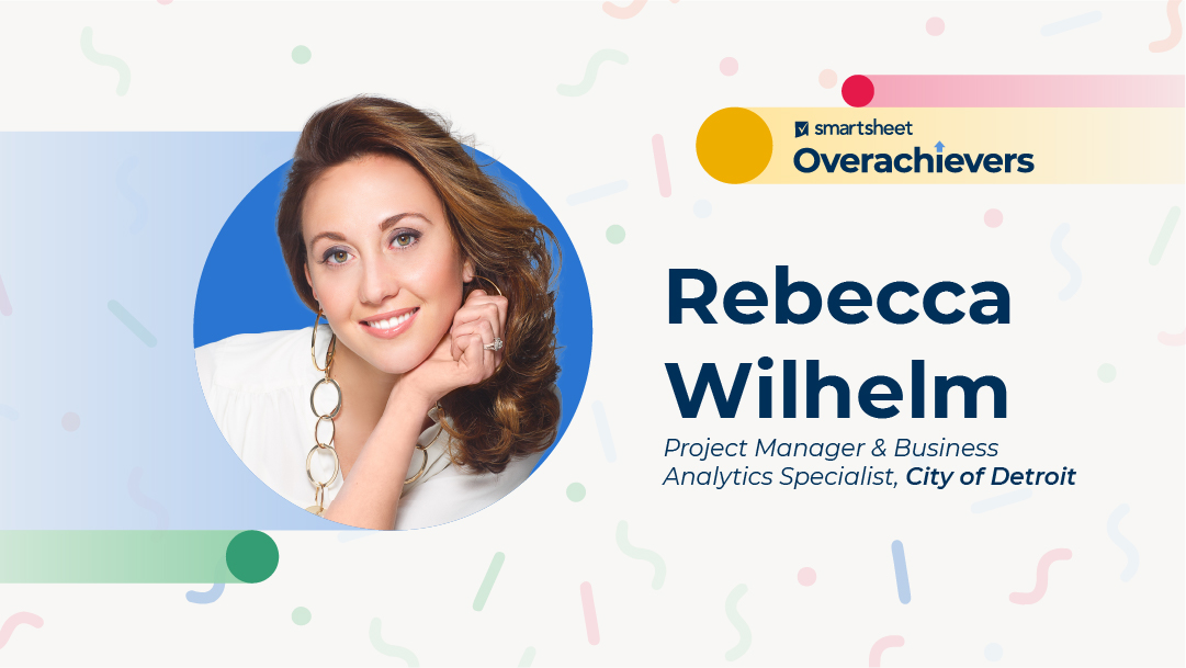 Woman with brown hair smiles in a portrait. Smartsheet Overachievers. Rebecca Wilhelm project manager and business analytics specialists City of Detroit