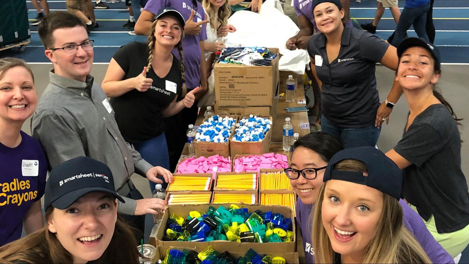 smartsheet employees packing boxes of school supplies