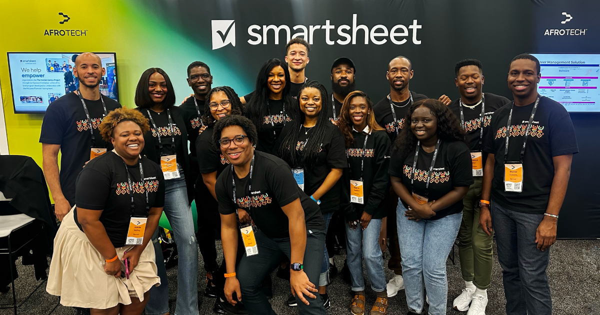 Members from the Black@Smartsheet ERG stand in front of the Smartsheet booth at the AFROTECH™ Conference 2023.