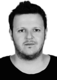 black and white photo of man looking at the camera