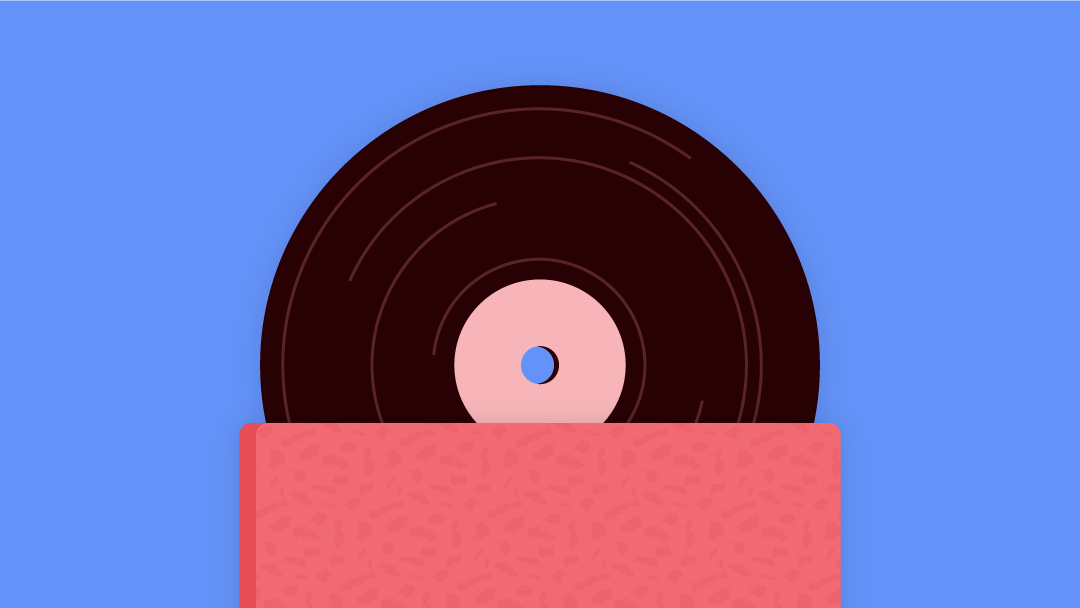 A stack of three vinyl record sleeves with a record visible on top.